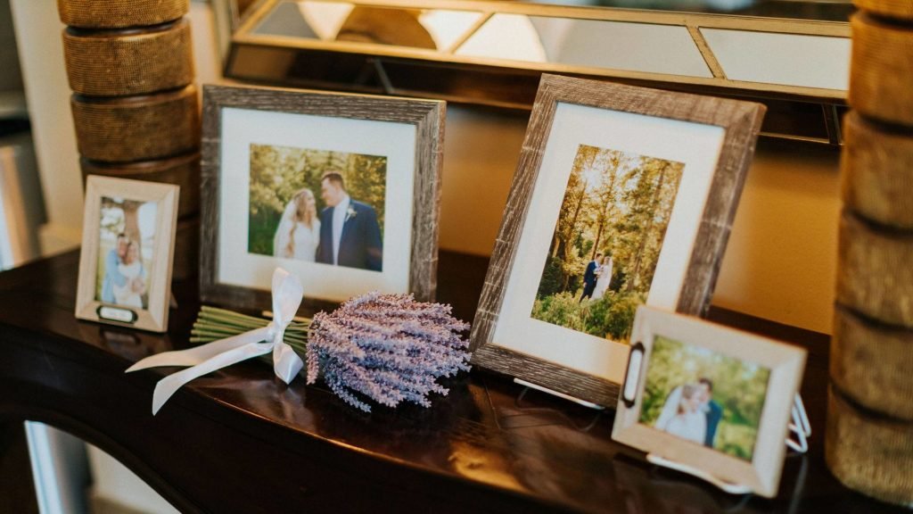 Framed engagement photos and lavender on a welcome table at a Bravo Event Center wedding reception